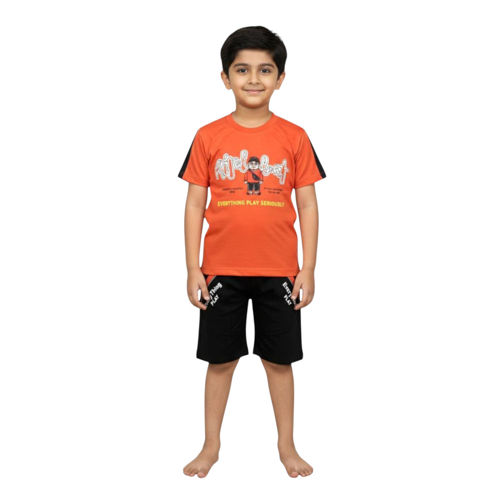 Mini & Mama Boys orange graphic t-shirt with black striped sleeves and black shorts with graphic print. Cotton blend.