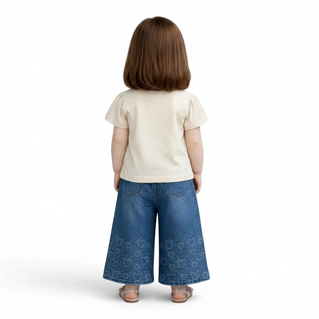 Mini & Mama cream t-shirt with puff sleeves and blue denim wide-leg pants with embroidered bear and heart pattern.