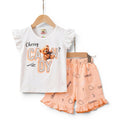 Mini & Mama Girls white t-shirt with ruffled sleeves and "Cherry Candy" teddy bear graphic, paired with peach shorts with candy print.