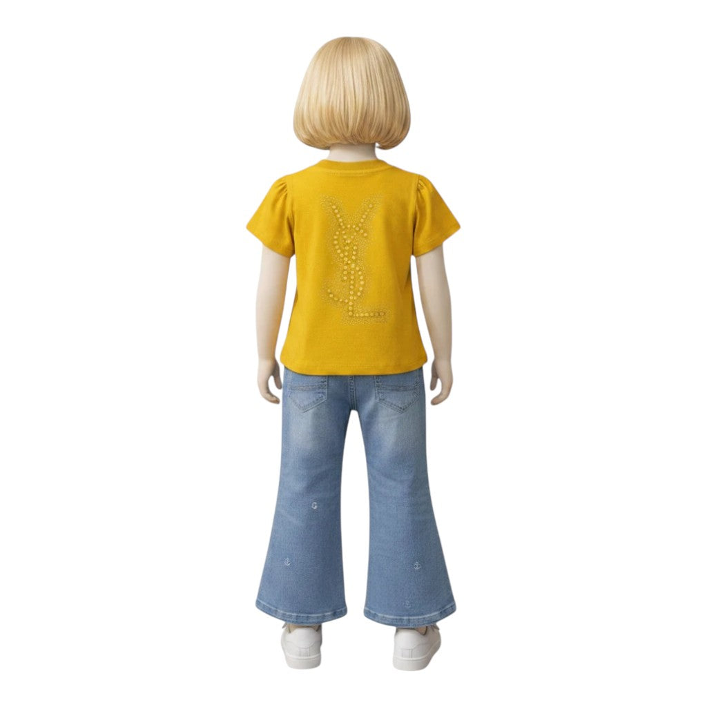 Mini & Mama yellow cotton t-shirt with embellished logo and puffed sleeves, paired with light-wash flare jeans with anchor embroidery.