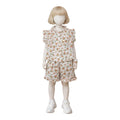 Mini & Mama Girls' white floral print pajama set with ruffle trim short sleeves and shorts.