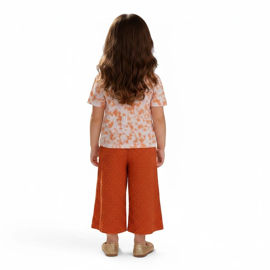 Mini & Mama Girls tie-dye t-shirt with orange swirl pattern and wide leg dobby dot pants in orange.