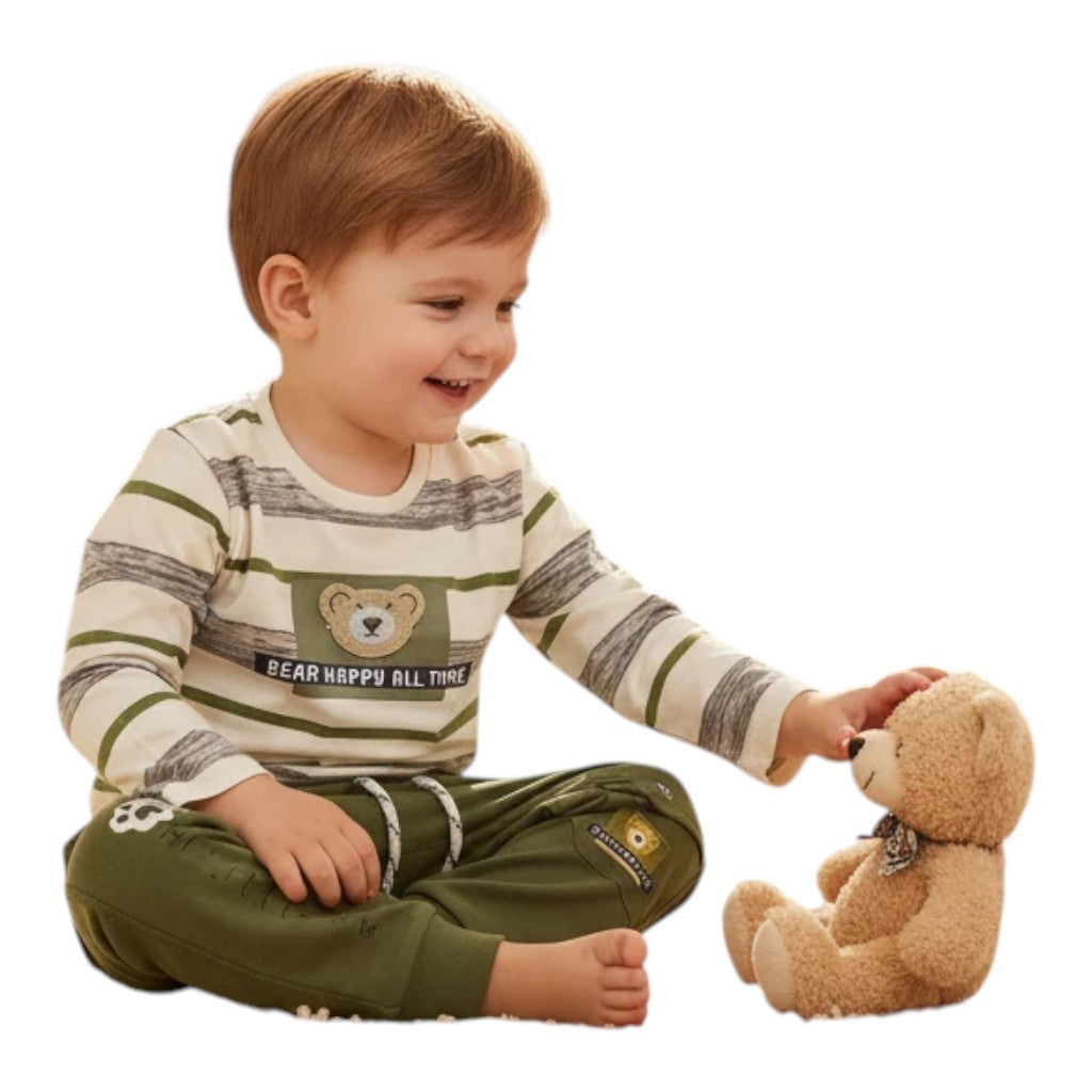 Mini & Mama striped long sleeve top with bear graphic and olive joggers. A young boy sits playing with a teddy bear.