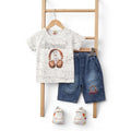 Mini & Mama boys white cotton graphic t-shirt with headphones and "disposal" text, paired with blue denim shorts. Includes sneakers.