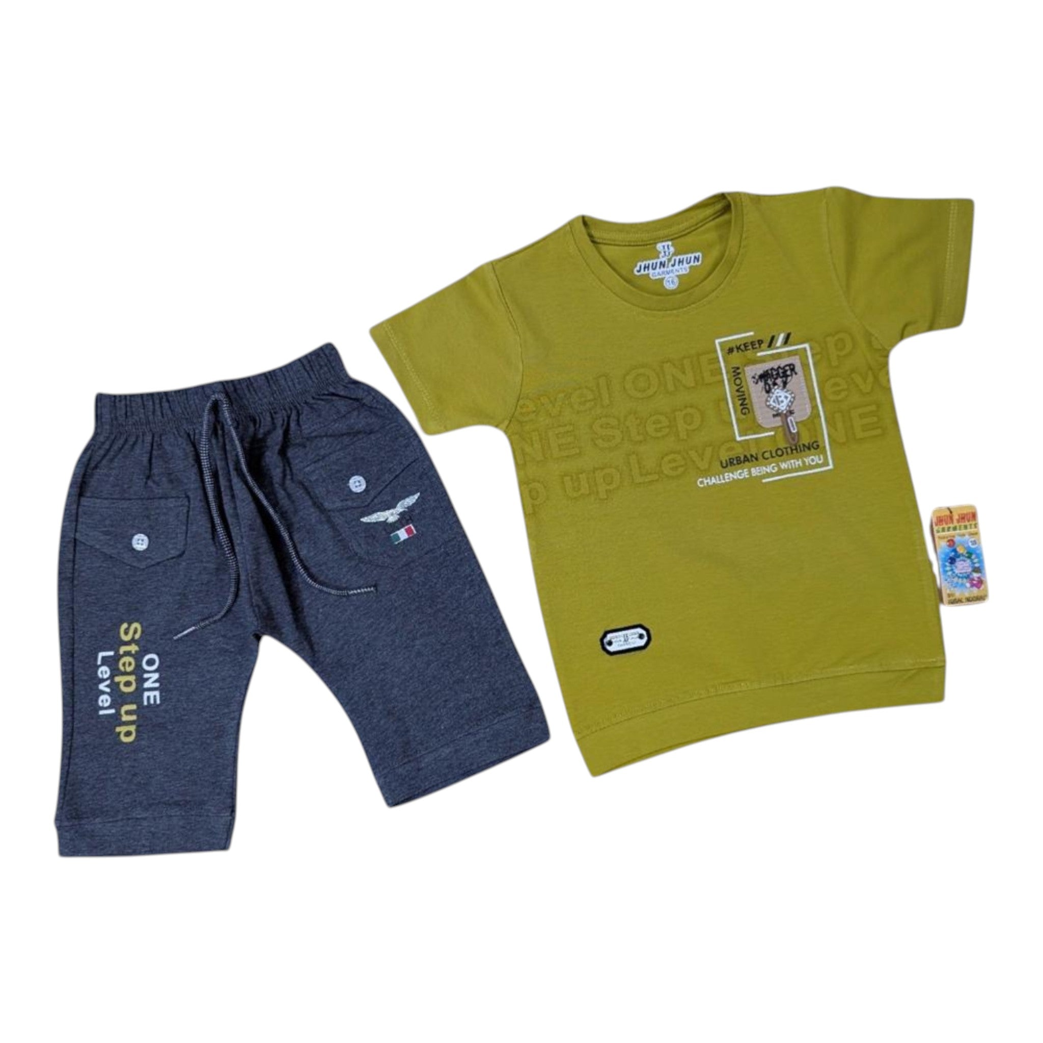 Mini & Mama boys' olive green graphic t-shirt and charcoal grey shorts set. Cotton blend t-shirt with "URBAN CLOTHING" graphic. Shorts have elastic waist, drawstring, and "Step up Level ONE" print.