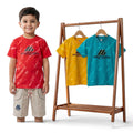Mini & Mama Boys red tie-dye graphic t-shirt and beige shorts set. Three t-shirts on rack: red, yellow, blue.