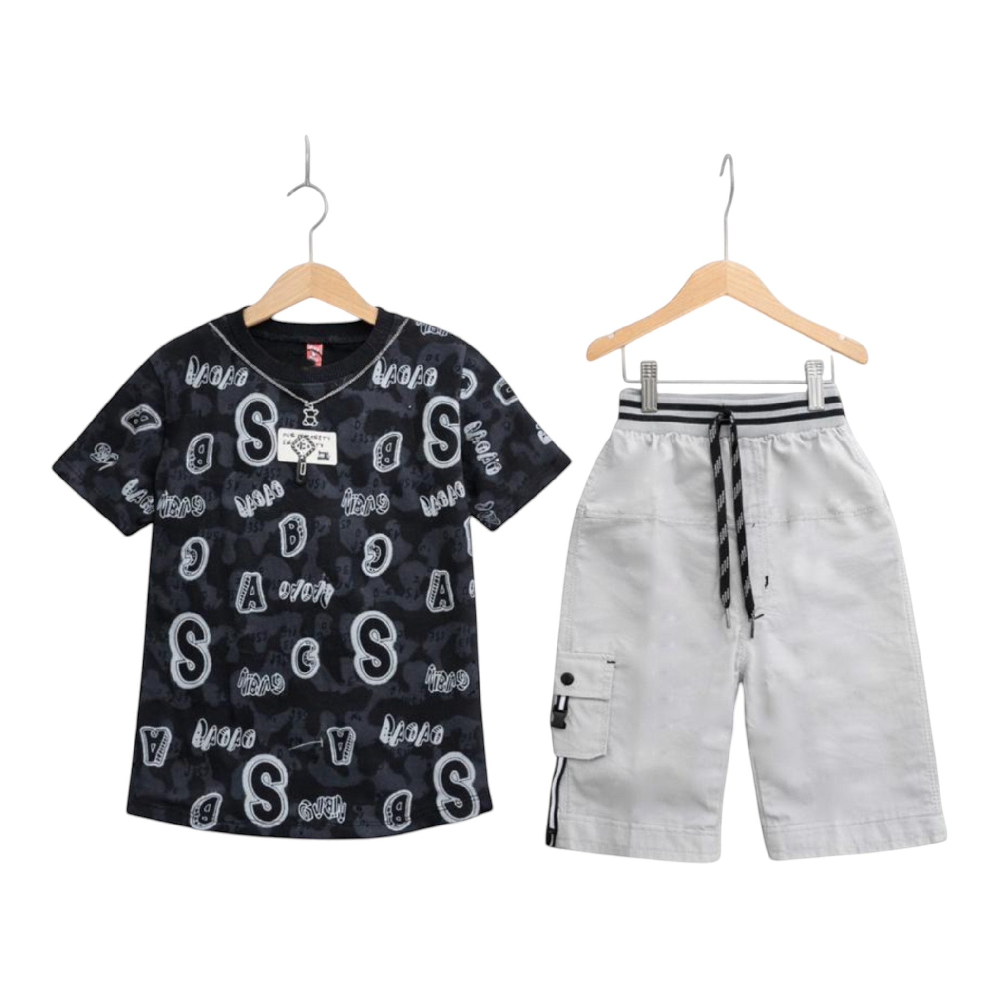 Mini & Mama Boys black graphic t-shirt and white cargo shorts set. T-shirt has all-over letter print. Shorts have drawstring waist and multiple pockets.