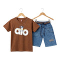 Mini & Mama boys' brown cotton t-shirt with "alo" graphic and speckled detail, paired with blue denim shorts. Elastic waistband and drawstring.