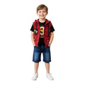 Mini & Mama red quilted hooded vest with patches and blue denim shorts set on a smiling boy.