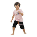Mini & Mama Boys pink graphic t-shirt and black shorts set with "RAVEN Keep On Going" print. Adjustable drawstring waist.