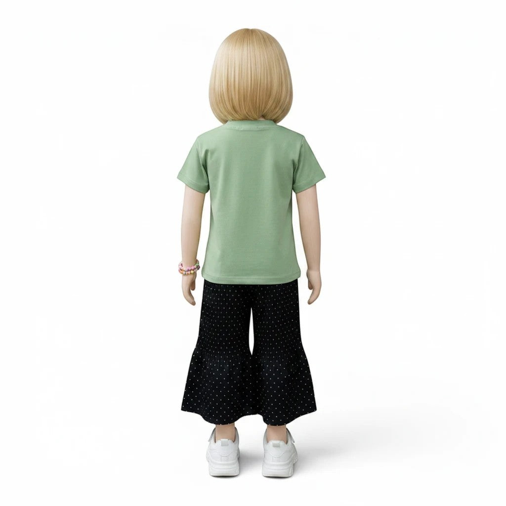 Mini & Mama girls' light green short-sleeve top with floral embellishments and black polka dot flared pants.