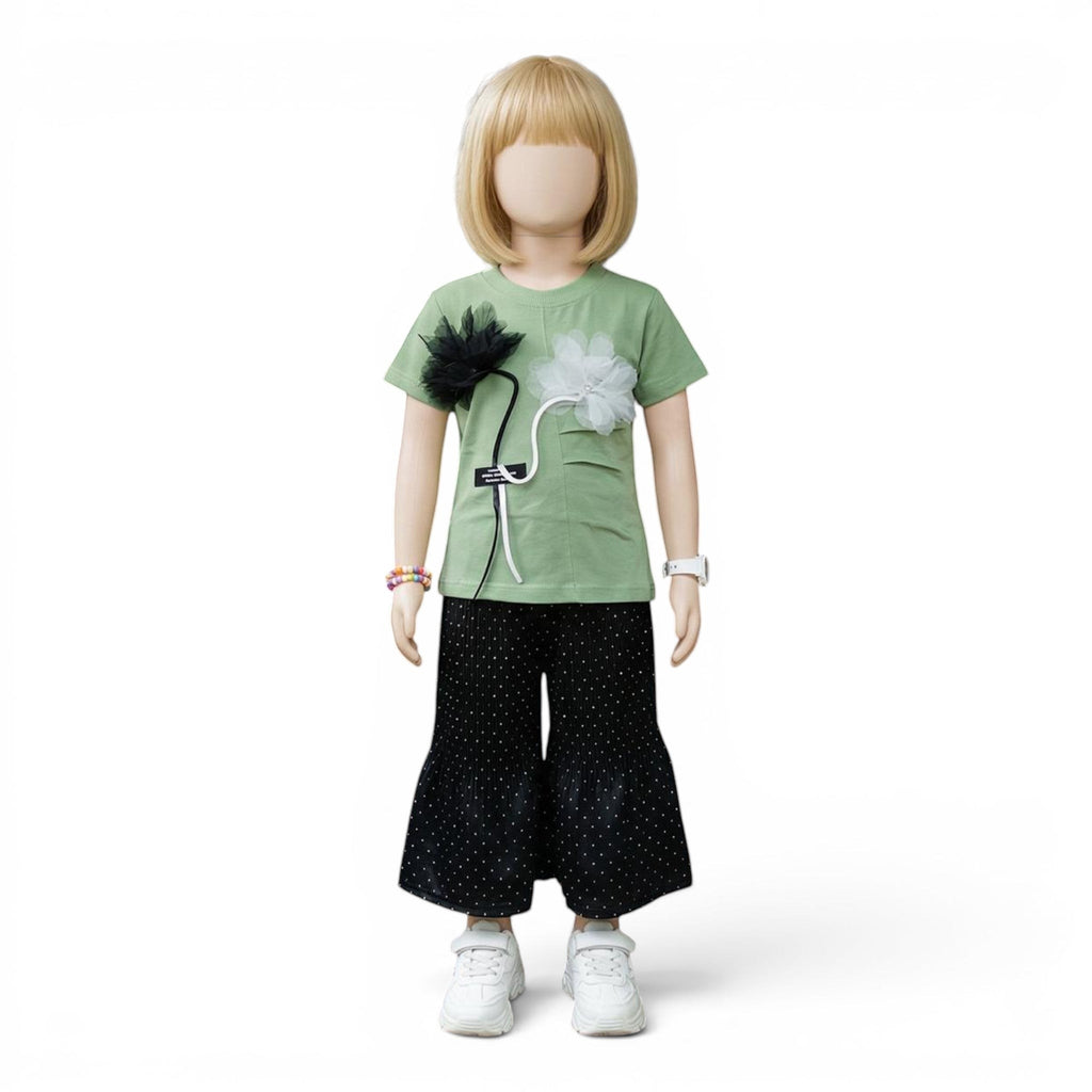 Mini & Mama light green short-sleeve top with floral embellishments and black polka dot wide-leg pants.