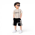 Mini & Mama Kids beige and brown geometric print t-shirt with black shorts set. Features text graphics.