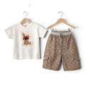 Mini & Mama cream graphic t-shirt with bunny and brown patterned shorts with cargo pockets.