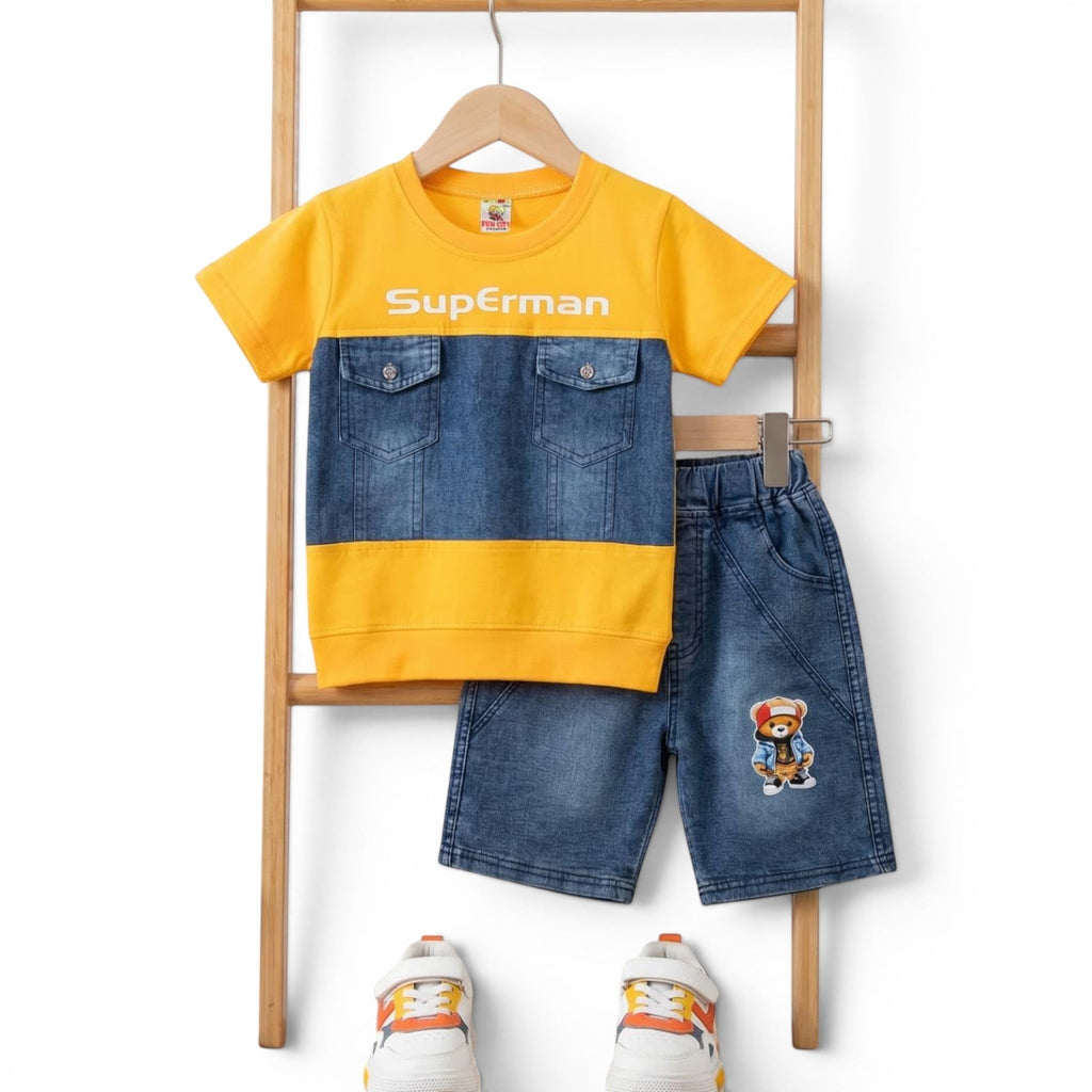 Mini & Mama boys' yellow and blue denim-look Superman two-piece outfit with shorts featuring a teddy bear graphic.